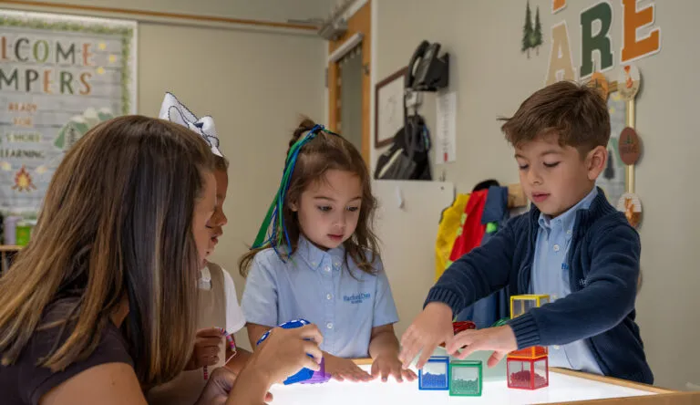 A diverse group of K-Prep students at Harford Day School learn with bead blocks